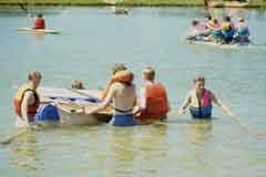 Youngsters enjoying a raft race at the Lakeside Country Park, Eastleigh, created from former sand and gravel workings.